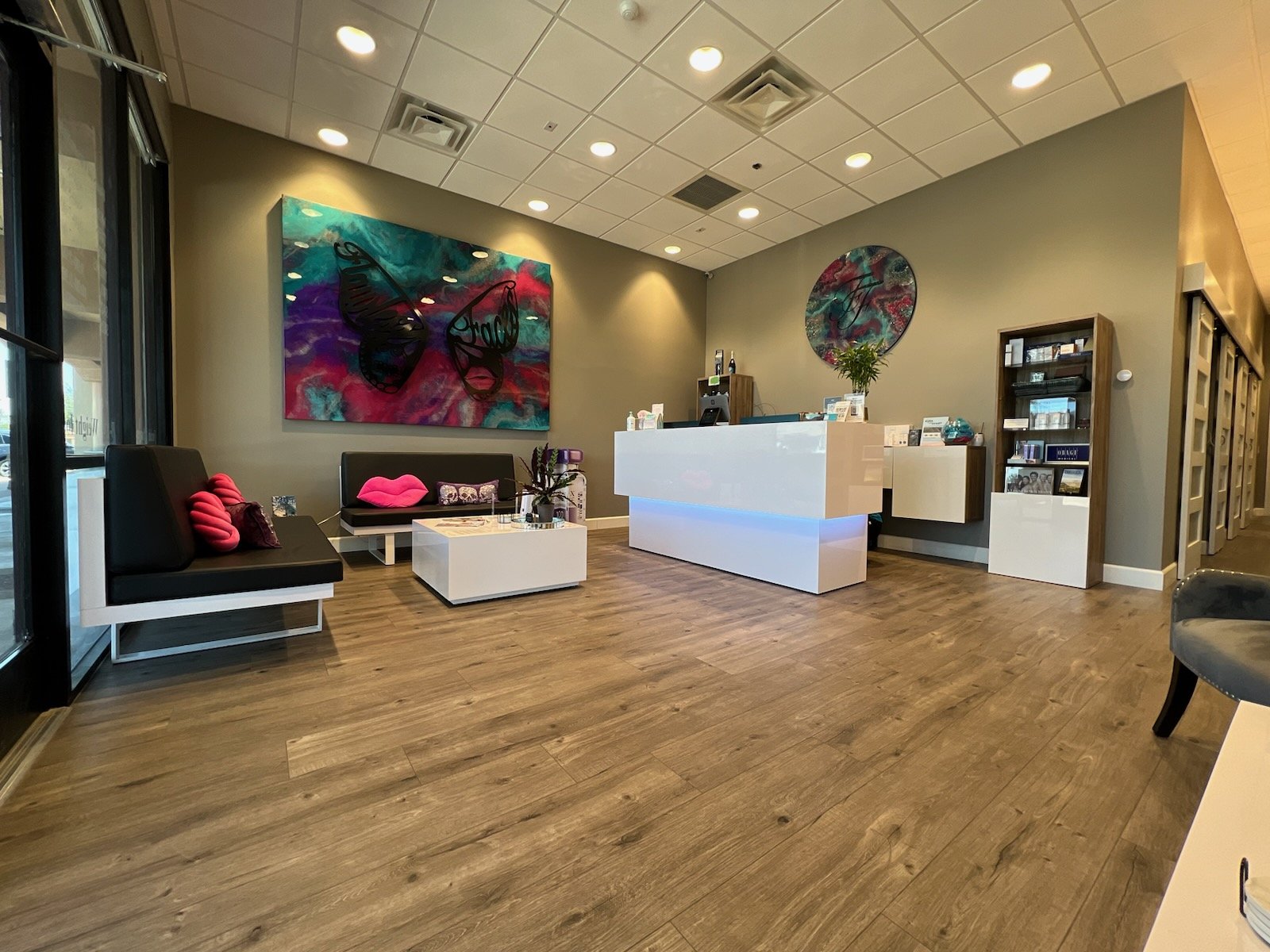 Flawless Faces Medical Spa reception lobby — butterfly resin art and white reception desk in Chandler, Arizona