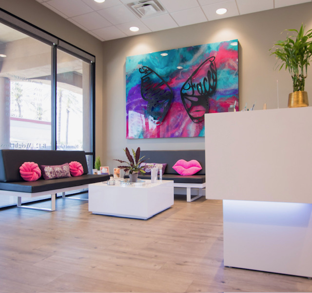 Flawless Faces Med Spa Chandler AZ lobby with signature butterfly and lips resin art on the back wall